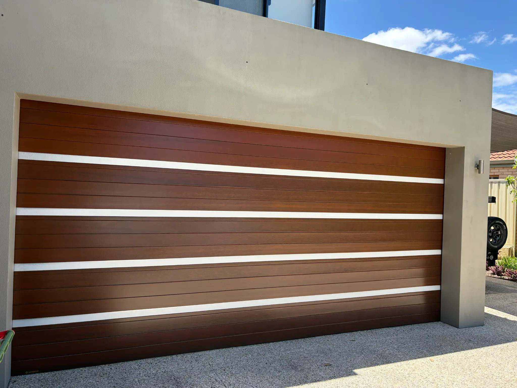 Finished cedar garage door restoration by JD Painting
